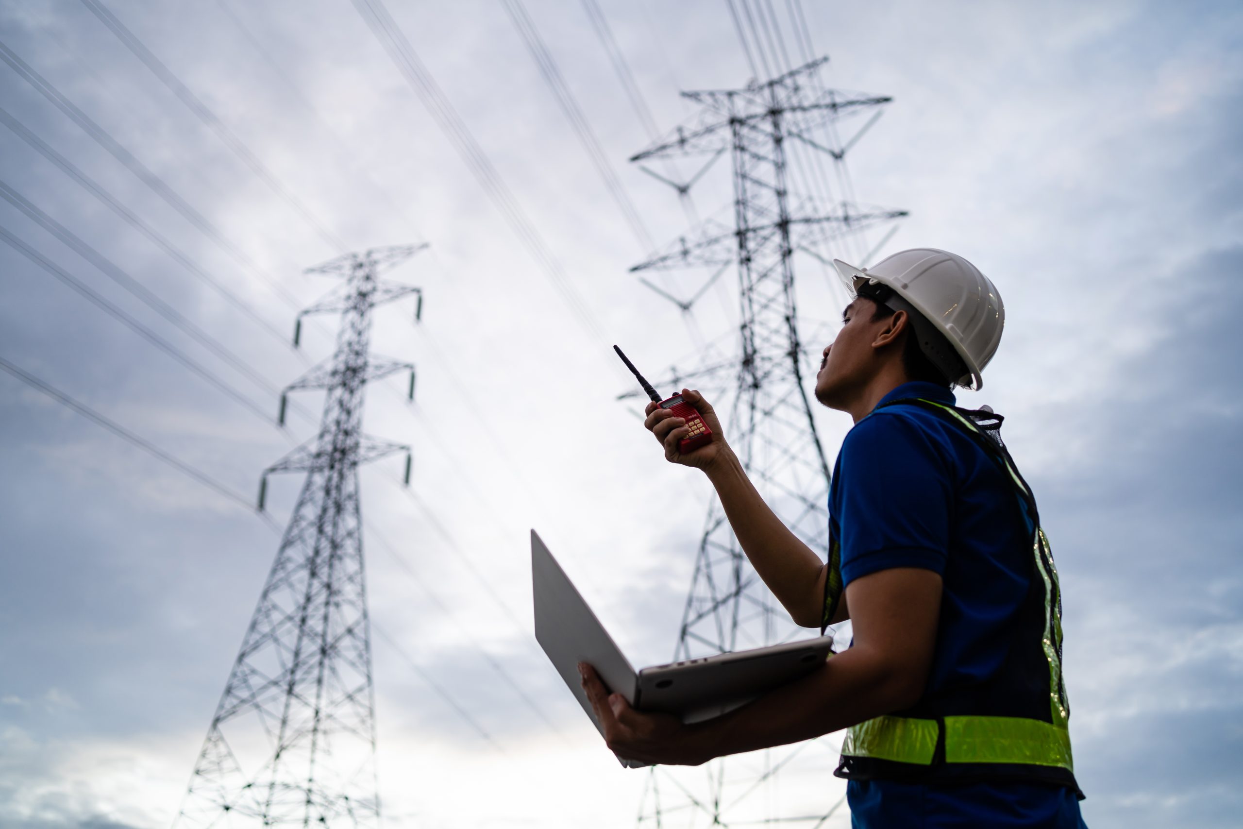 Asian engineer at power station using digital tablet working night shift at petroleum oil refinery in engineering industrial estate Fuel, renewable energy, industrial plants